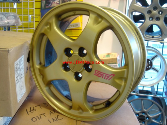 RI23005 - JDM Subaru STI Version 5 wheels in gold, 16x7 +53 offset 5x100 bolt pattern. Clear Subaru 4/2 pot brakes.