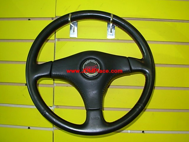 AC26001 - Rare JDM 22B STI Impreza steering wheel made by Nardi, non air bag with red stitch and carbon fiber STI horn cap. Fits most Subaru models.
